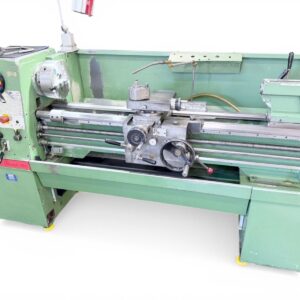 Industrial green metal lathe machine with control panel on left and hand cranks, used for turning cylindrical parts in a workshop